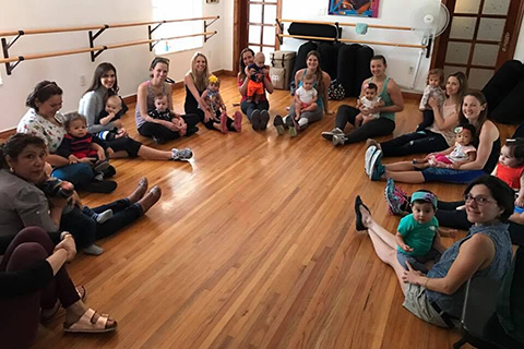 Children sitting with their family in a circle