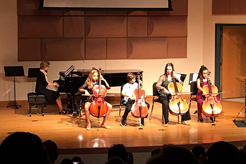 Youth strings ensemble perform on stage