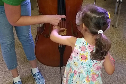 Child learning about a new instrument