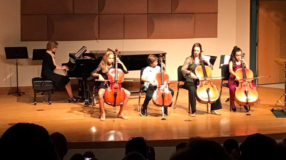 student strings group performs on stage